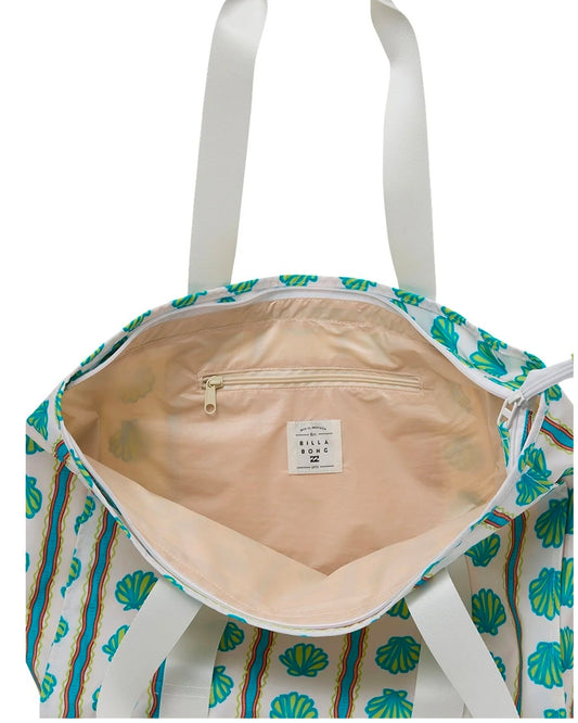 Tote bag with shell pattern and visible brand label on a white background