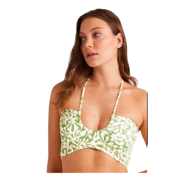 Woman wearing a green floral bikini set on a white background