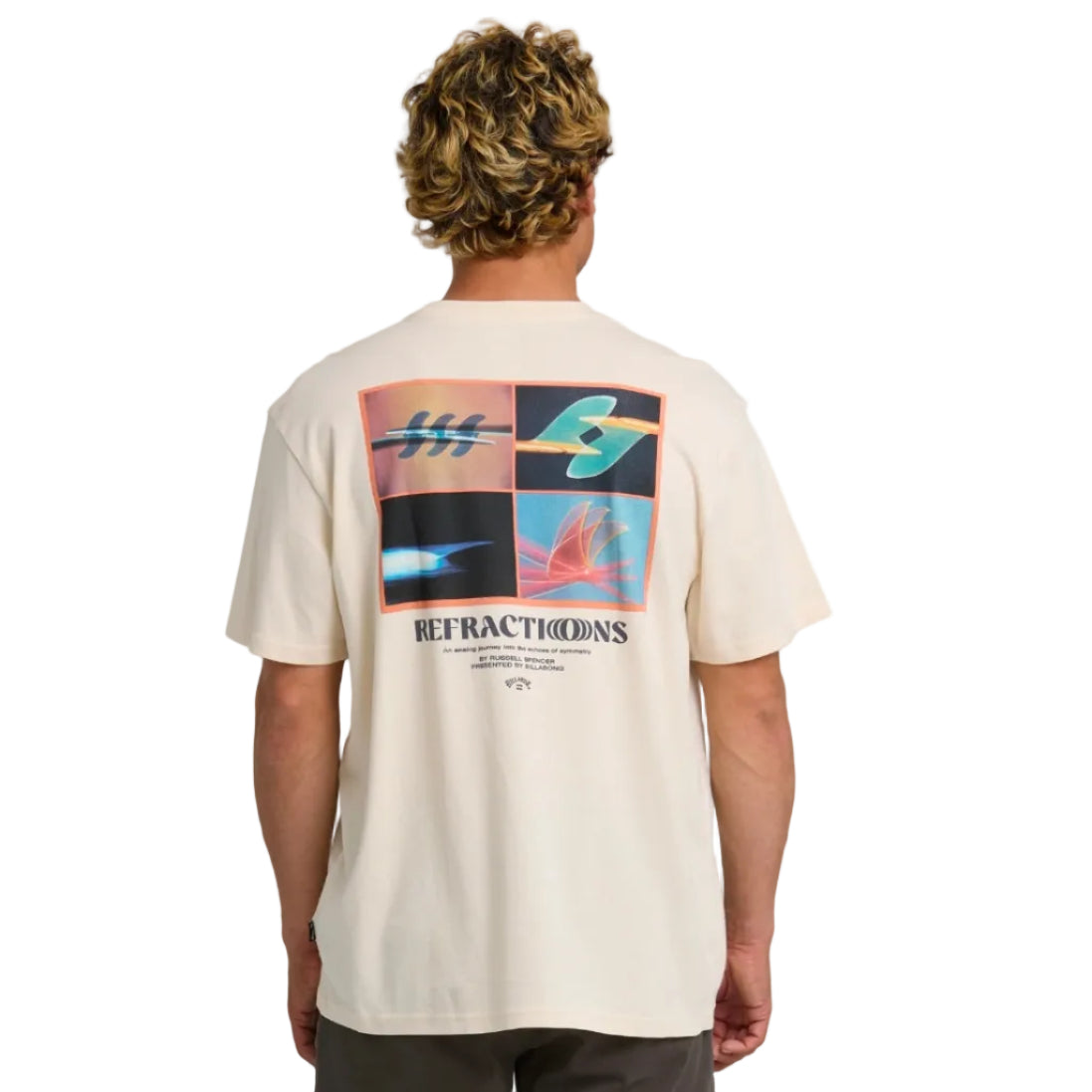 Person wearing a beige t-shirt with a colorful graphic on the back against a white background