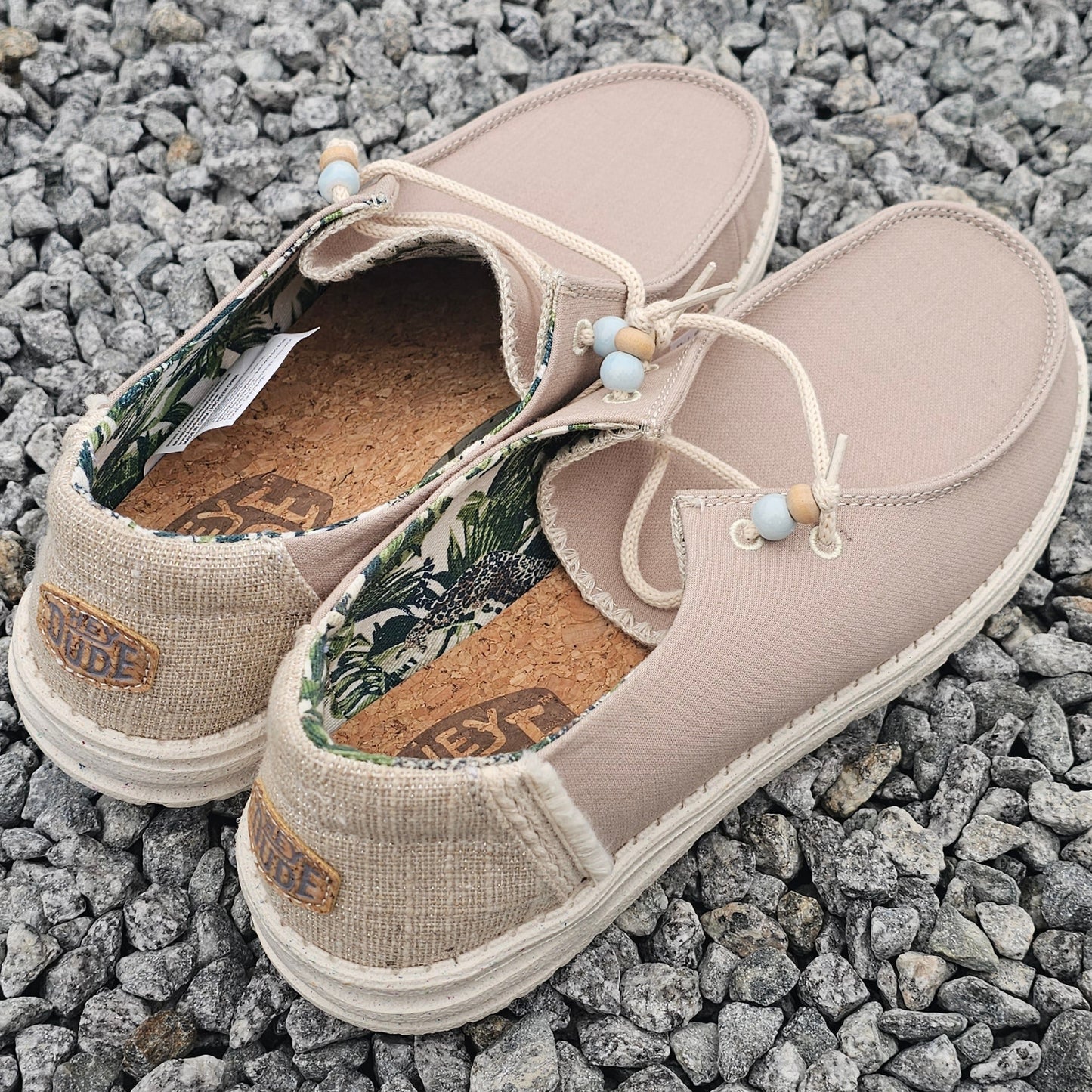 Pair of beige shoes on a textured gray surface