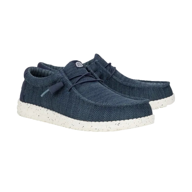 Pair of blue knit shoes with white soles on a white background