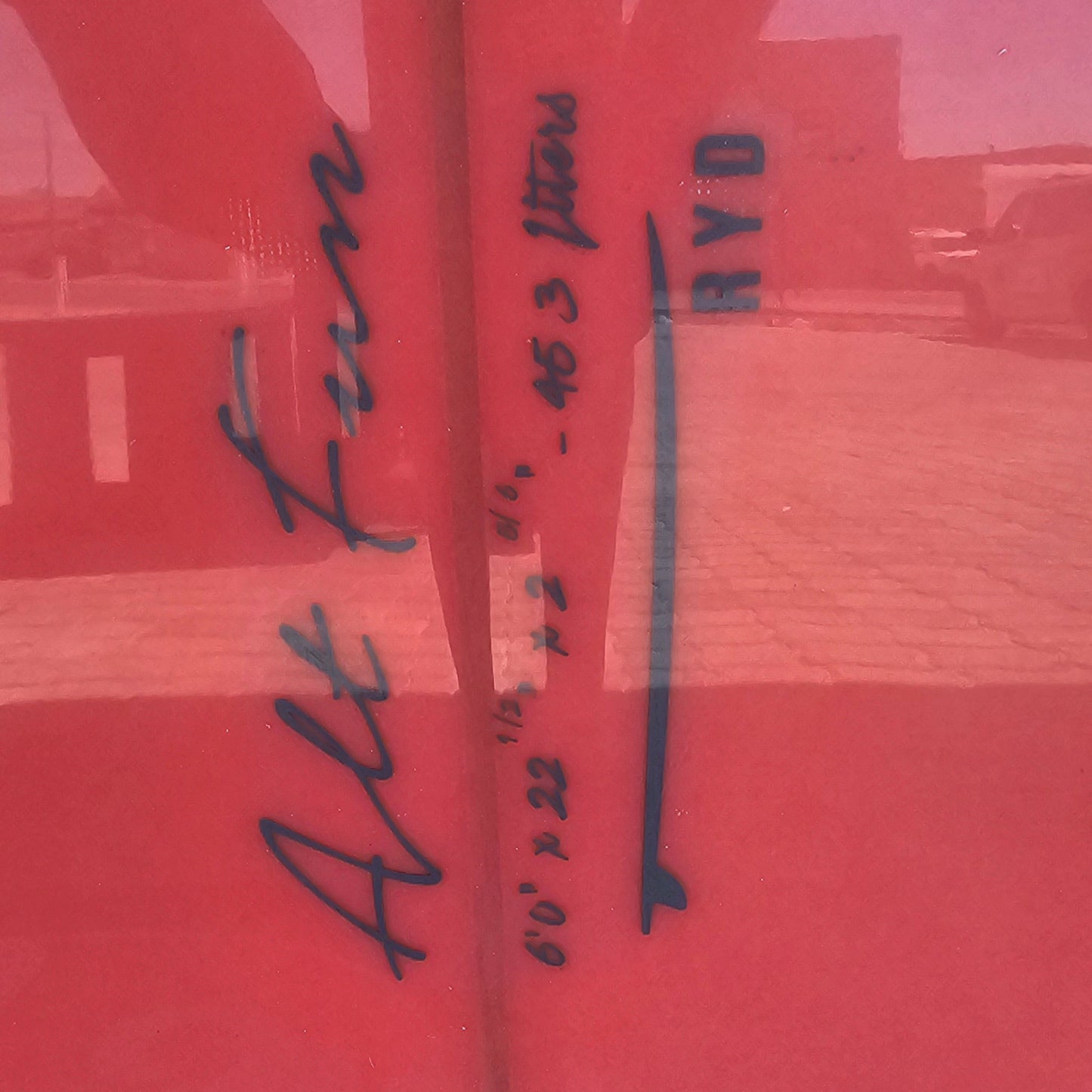 Red surface with black text and a white strip
