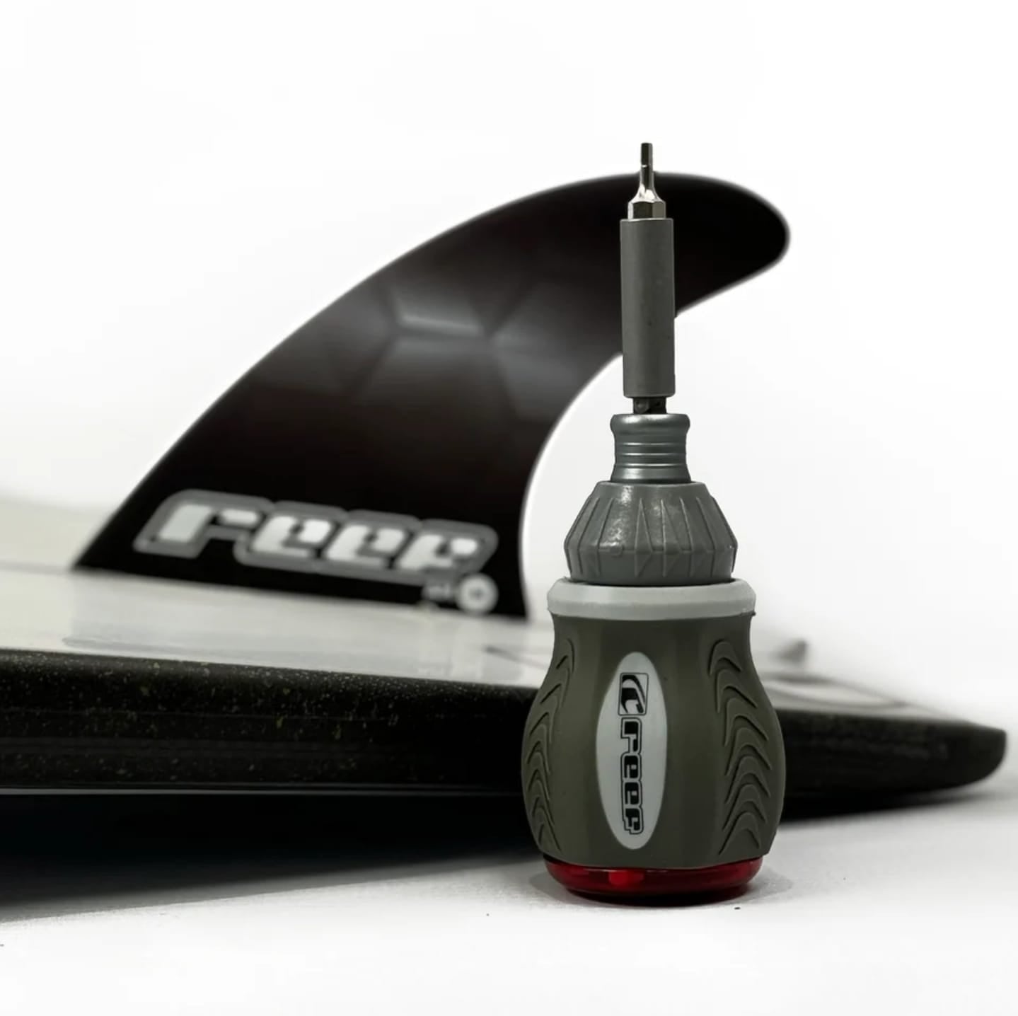 Surfboard fin with a fin tool on a white background