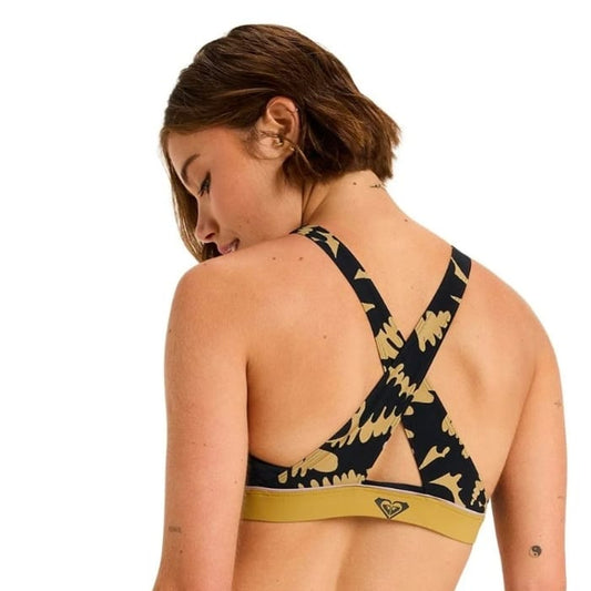 Woman wearing a black and gold bikini with a brand logo on a white background
