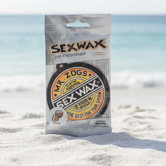 Sexwax air freshener packaging on a beach with ocean in the background