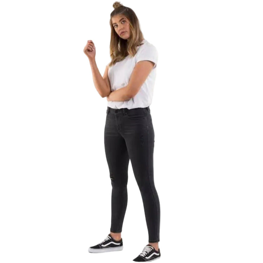 Woman wearing a white t-shirt and black jeans on a white background