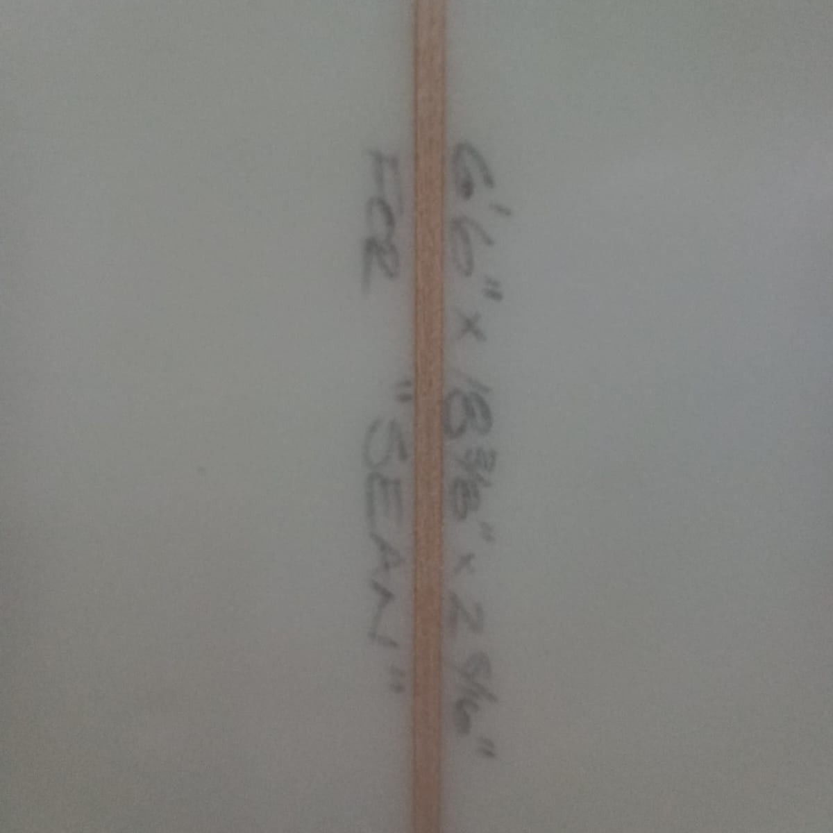 Measurement label on a white surface with text and a line.
