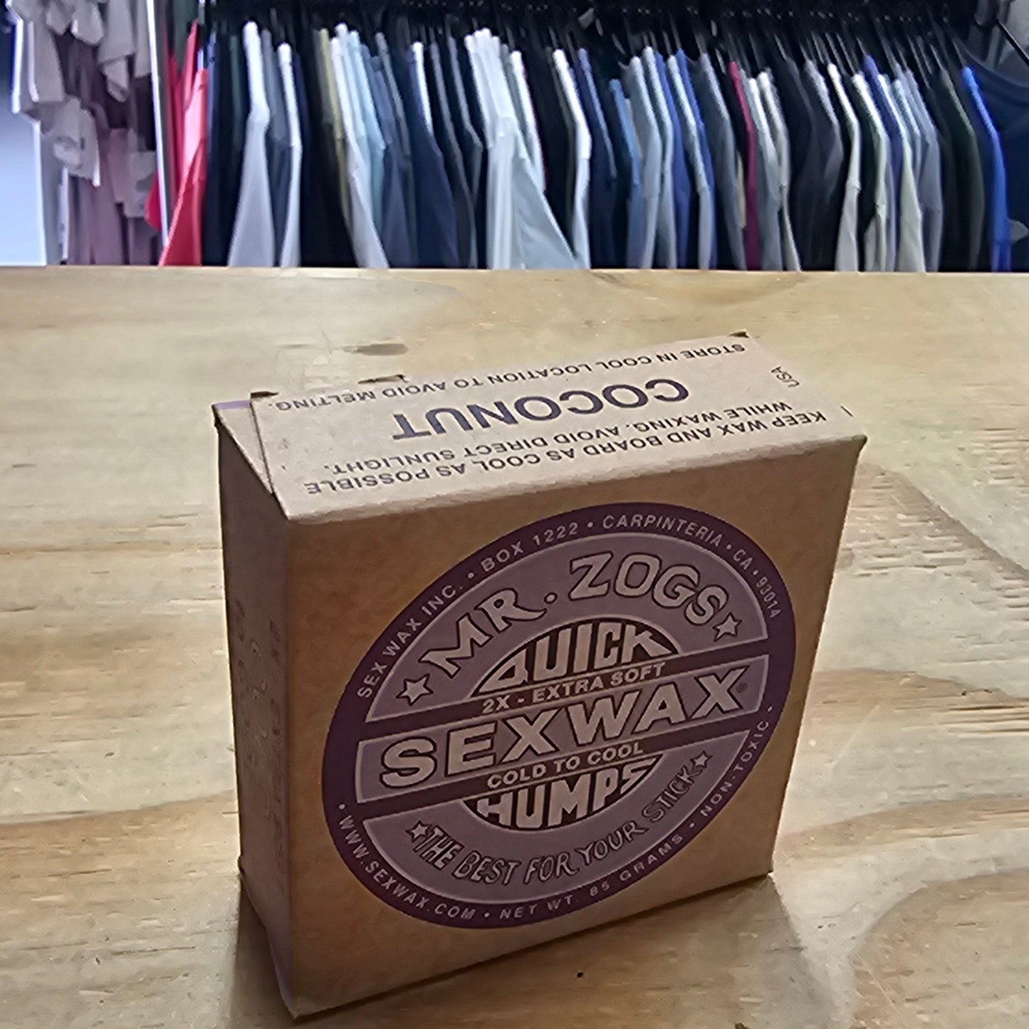Box of wax on a wooden surface with a binder in the background
