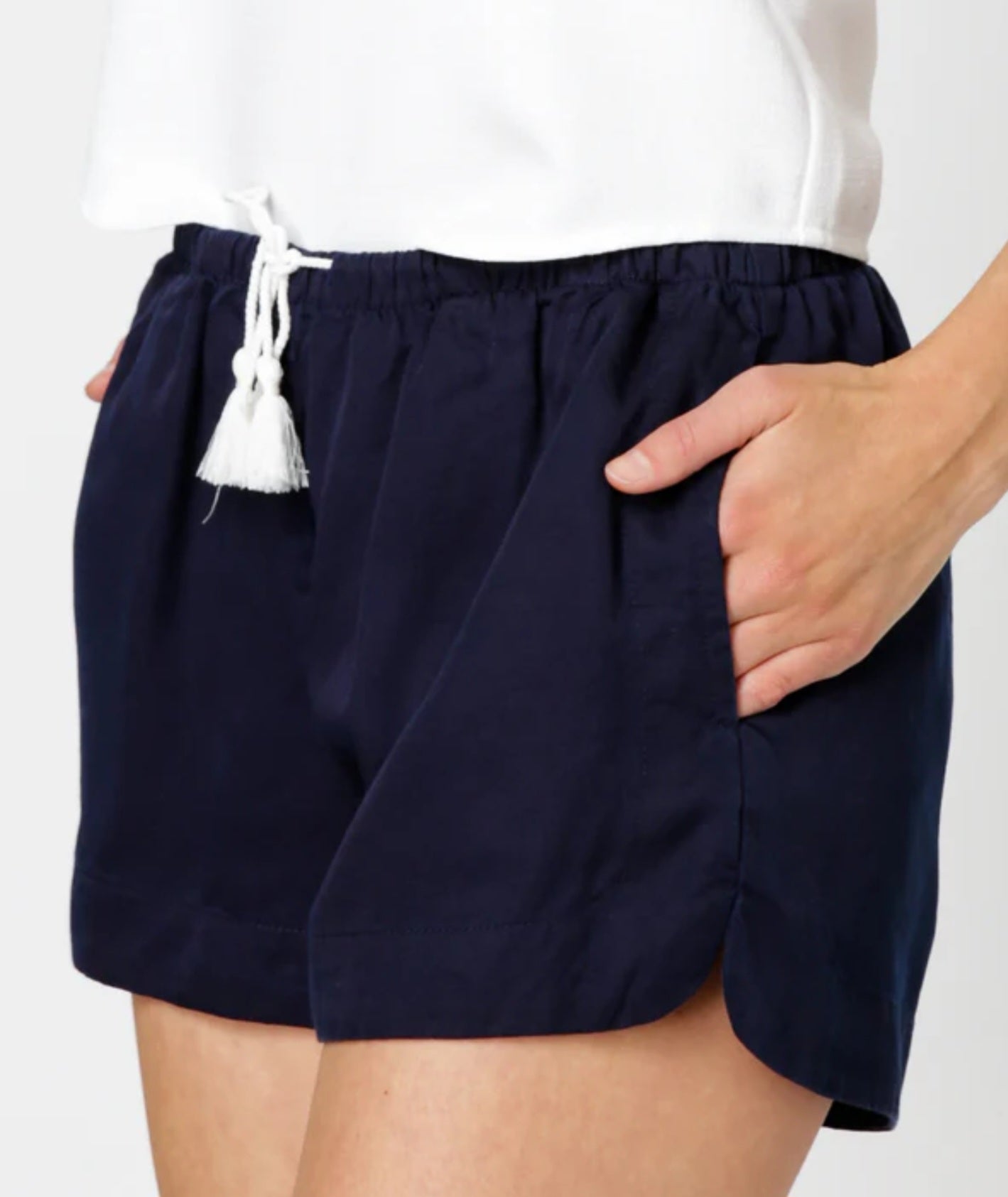 Navy shorts with a white tassel on a plain background