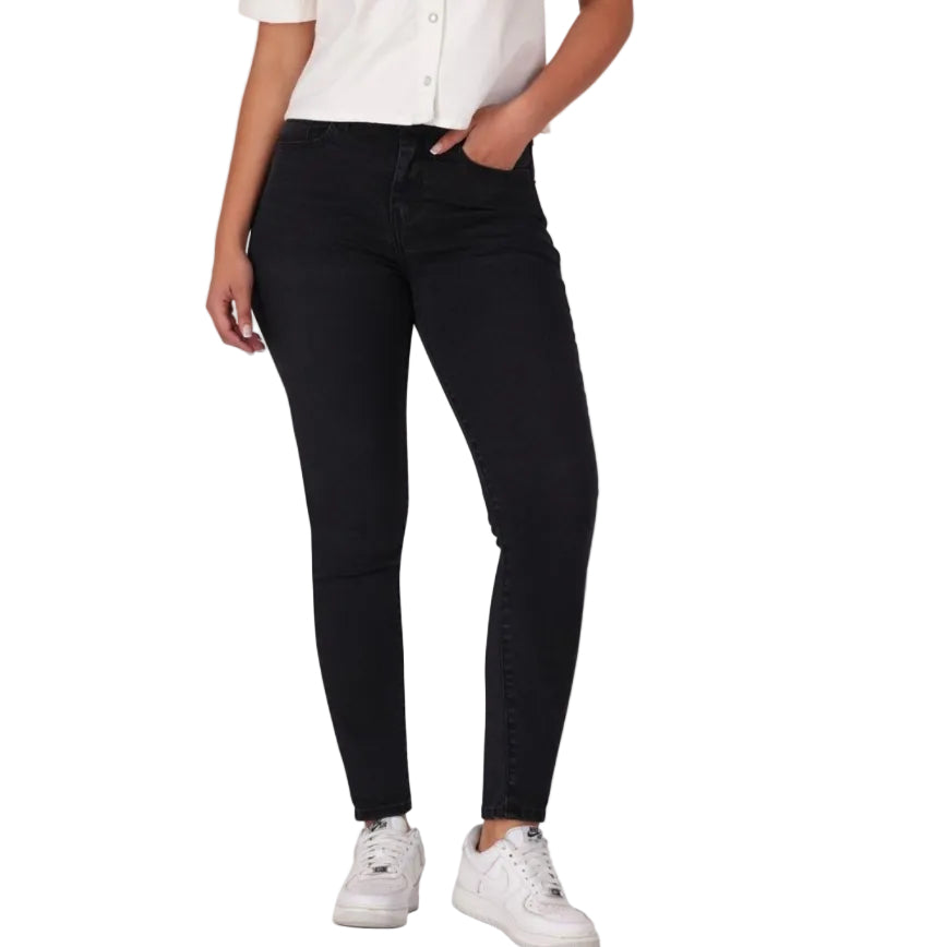Person wearing black jeans and white sneakers on a white background