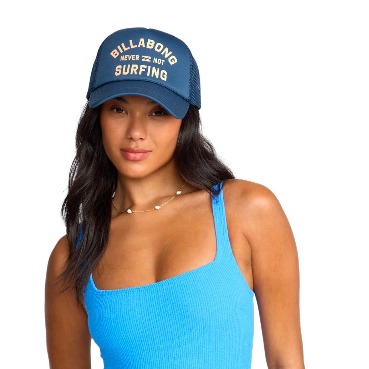 Woman wearing a blue Billabong cap and matching swimsuit on a white background