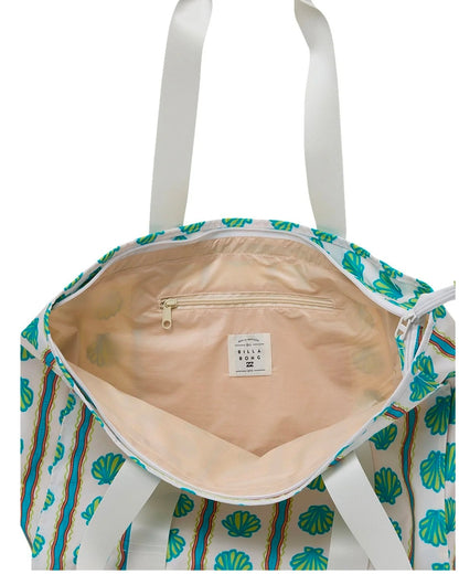 Tote bag with shell pattern and visible brand label on a white background
