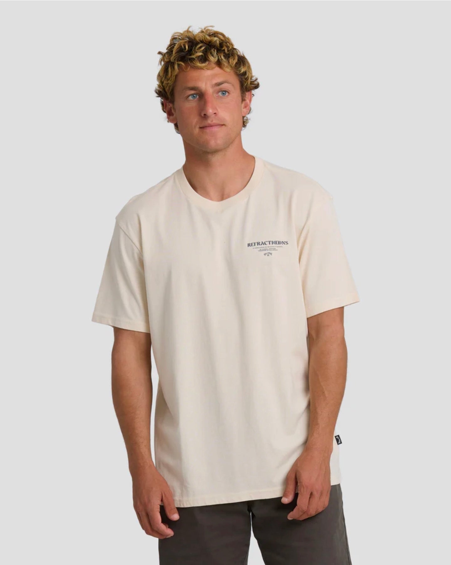 Man wearing a beige t-shirt with text on a plain background