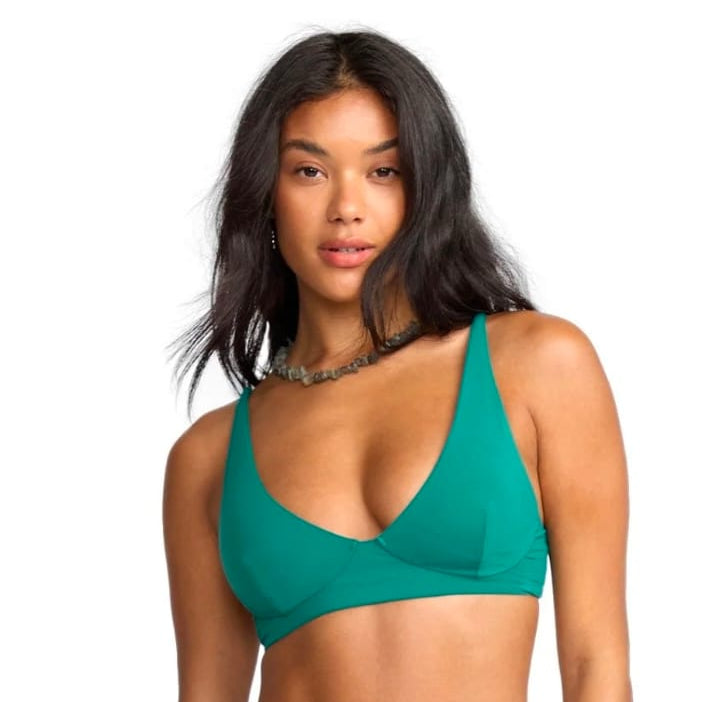 Woman wearing a green bikini set on a white background