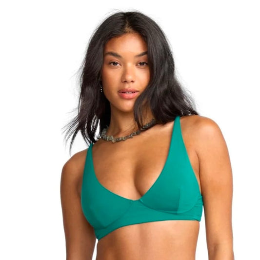 Woman wearing a green bikini set on a white background