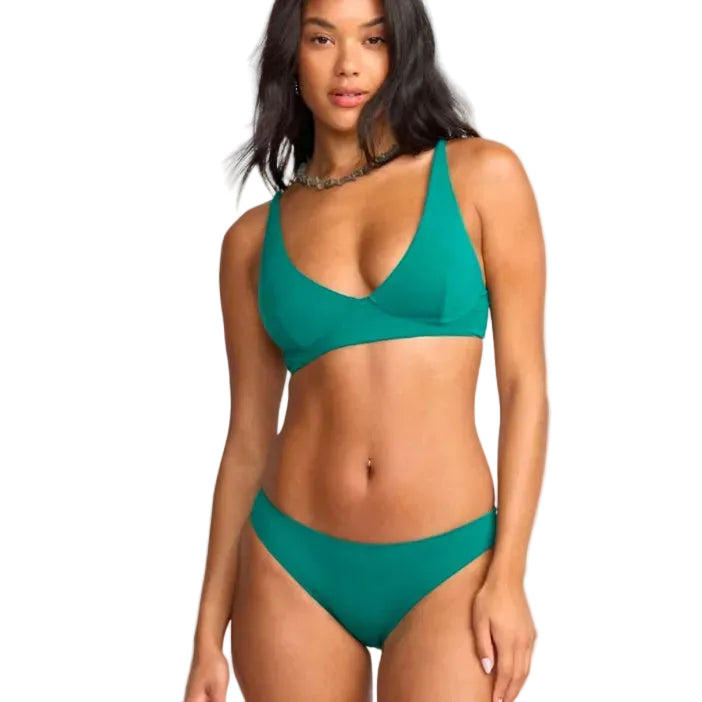 Woman wearing a green bikini set on a white background