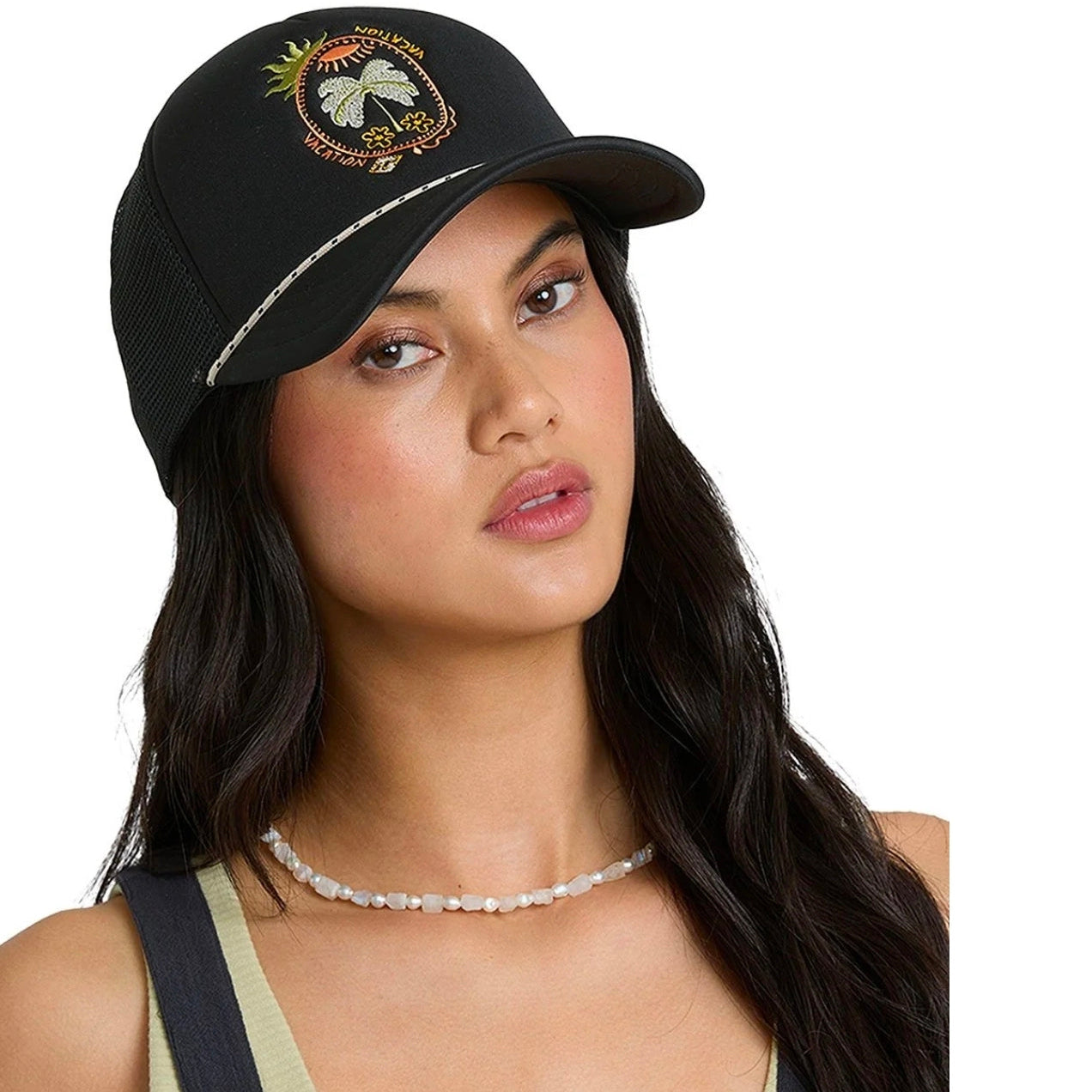 Woman wearing a black cap with embroidery on a white background