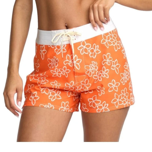 Orange floral-patterned shorts worn by a person on a white background