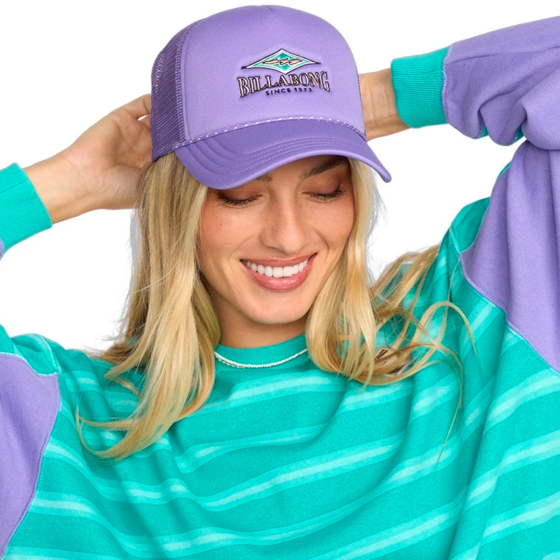 Woman wearing a purple cap and matching outfit with a visible brand logo.