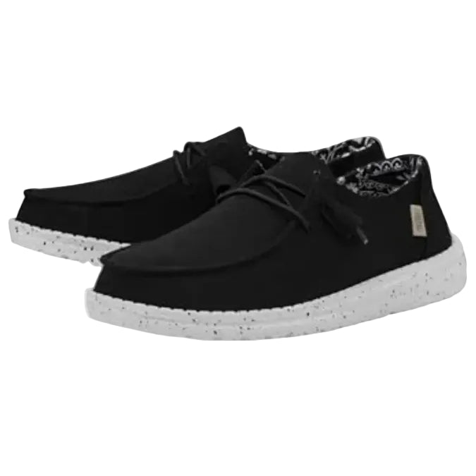 Black casual shoes with white soles on a white background