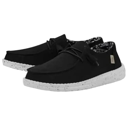 Black casual shoes with white soles on a white background