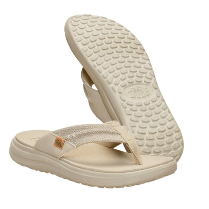 Beige flip-flops with textured sole on a white background