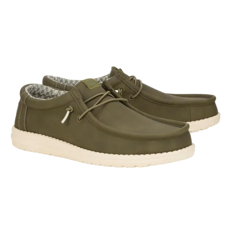 Pair of green casual shoes with white soles on a white background