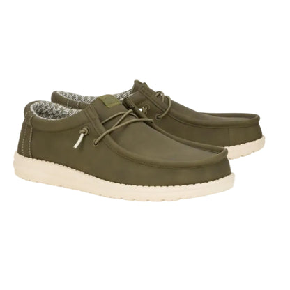Pair of green casual shoes with white soles on a white background