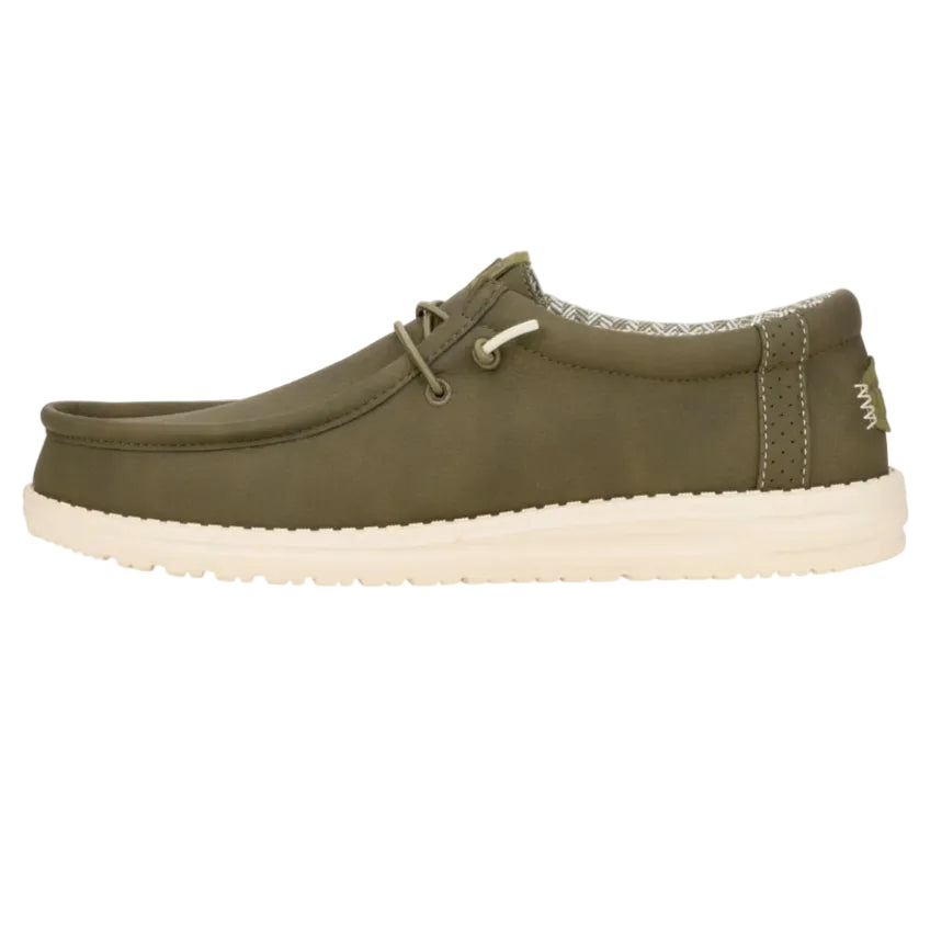 Green casual shoe with white sole on a white background