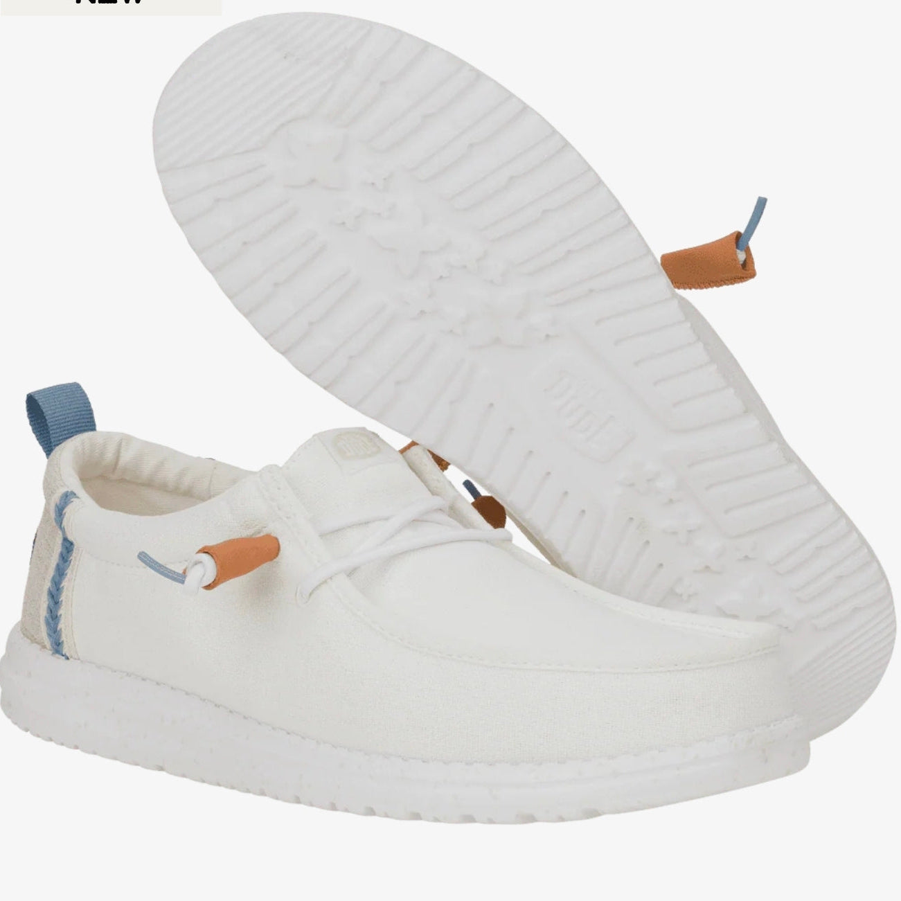 White slip-on shoes with brown accents on a white background