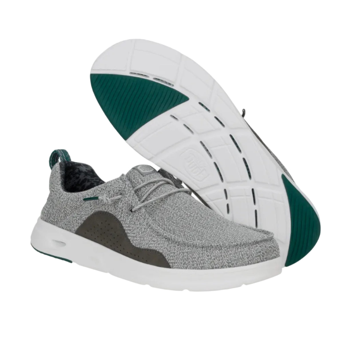 Gray sneakers with green accents on a white background