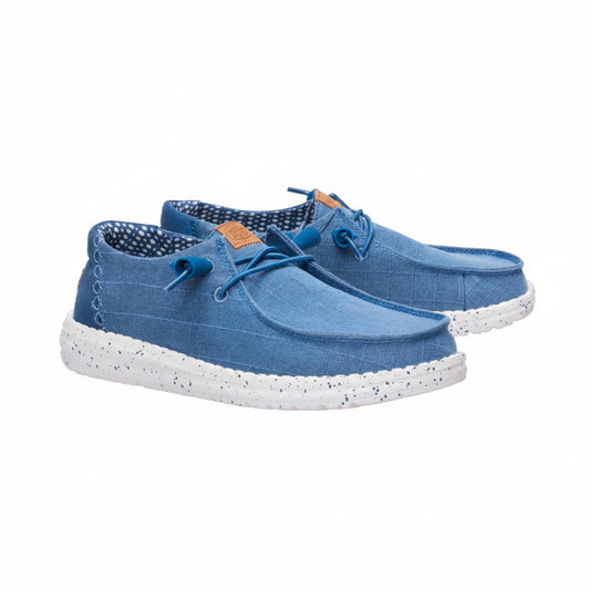 A pair of blue canvas lace-up shoes with white speckled soles, shown against a plain white background.