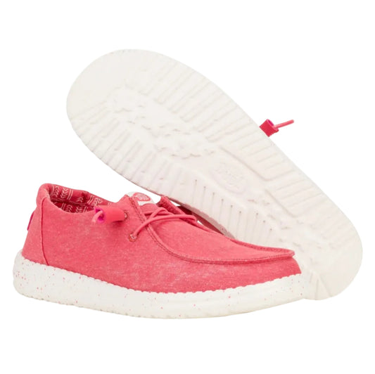 Pink casual shoe with white sole on a white background