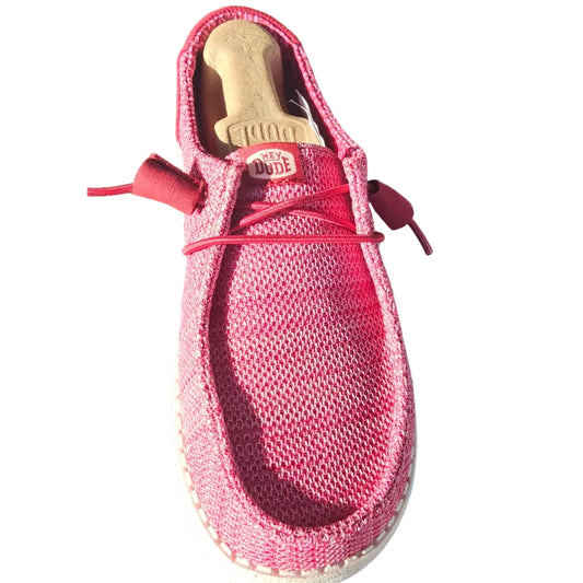 A pink knit slip-on shoe with red laces and a white sole, shown alongside its blue and white box.