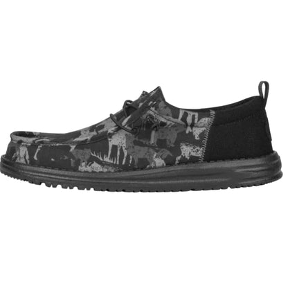 Black slip-on shoe with animal pattern on a white background