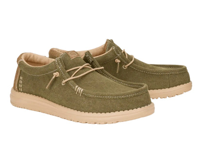Pair of green casual shoes with beige soles on a white background