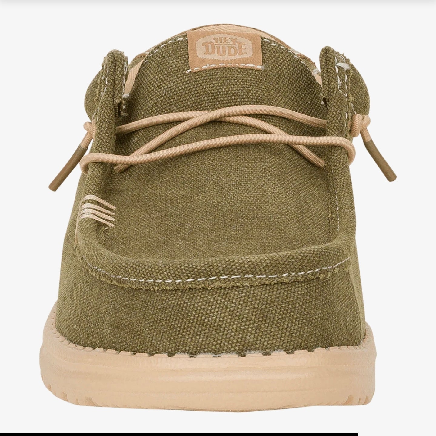 Green sneaker with beige laces and sole on a white background