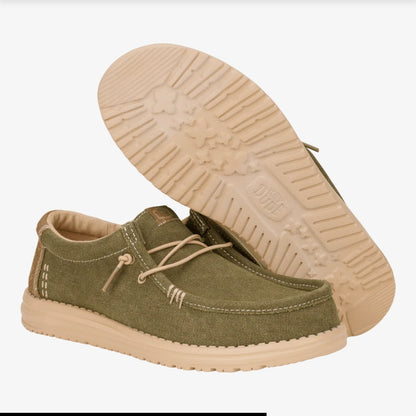 Green casual shoe with beige sole on a white background