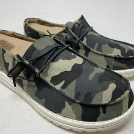 Camouflage-patterned shoes with white soles on a light gray background