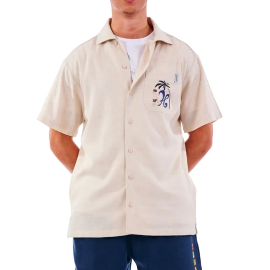 Beige button-up shirt with a palm tree design on a white background