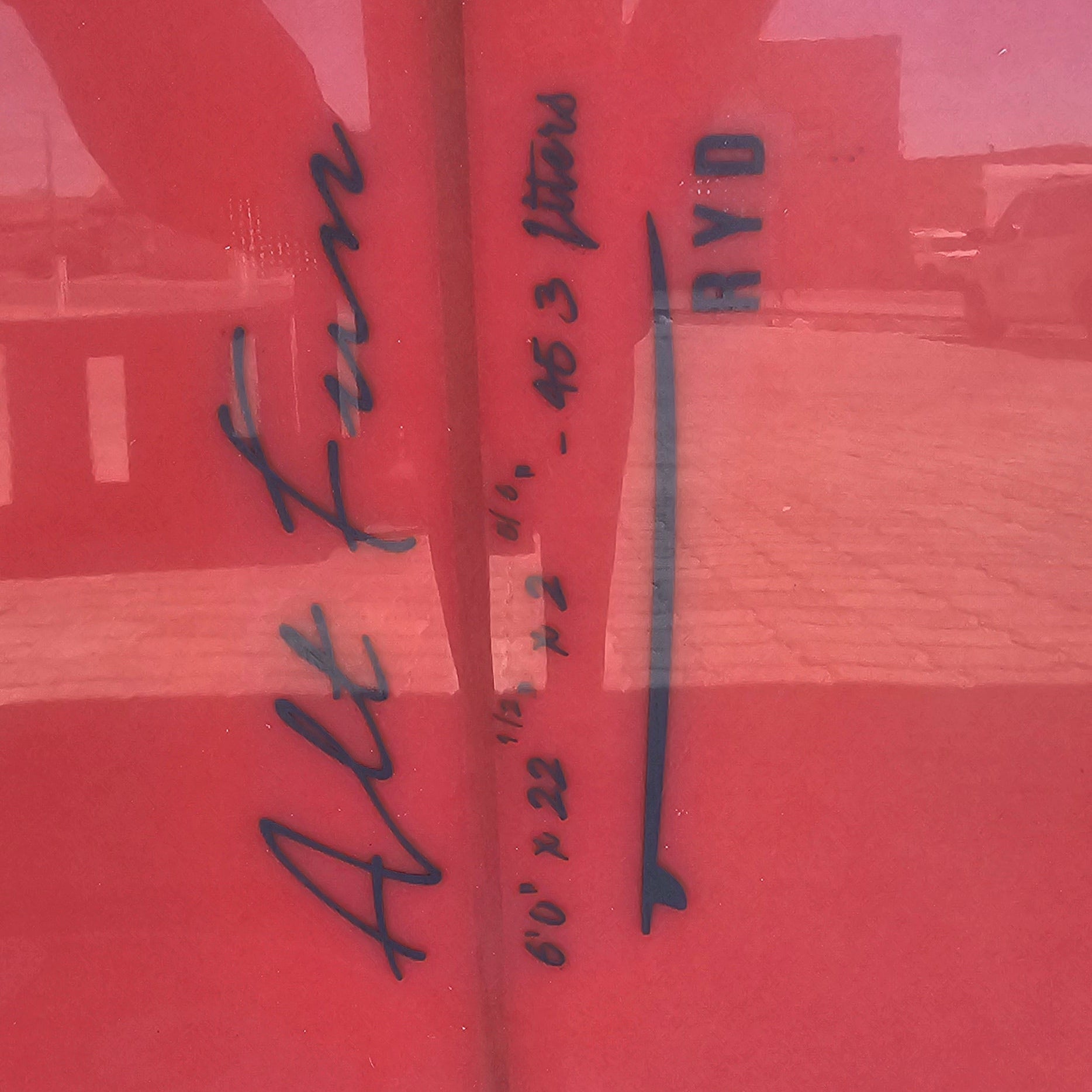 Red surface with black text and a white strip