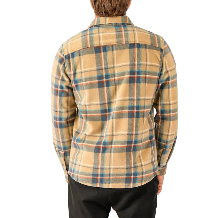 Person wearing a plaid shirt with a neutral color palette on a white background