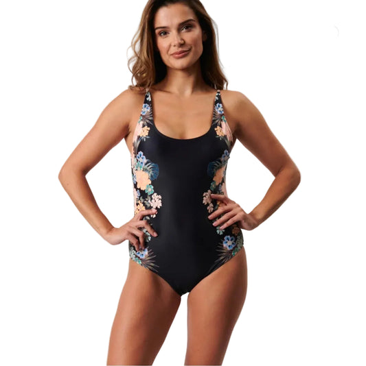 Woman wearing a black floral one-piece swimsuit on a light gray background