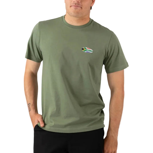 Person wearing a green t-shirt with a small flag logo on a white background