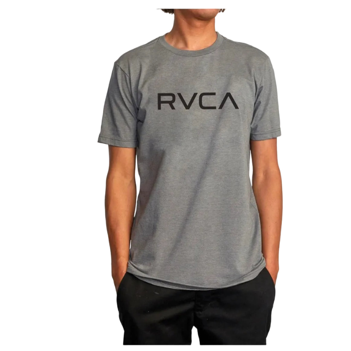 Person wearing a gray RVCA t-shirt on a white background