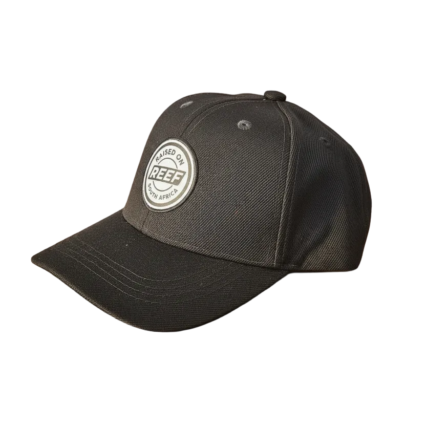 Black cap with a logo on a wooden surface