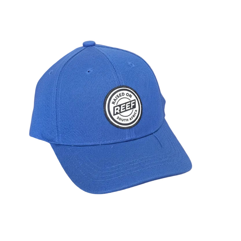 Blue cap with a Reef logo on a wooden surface