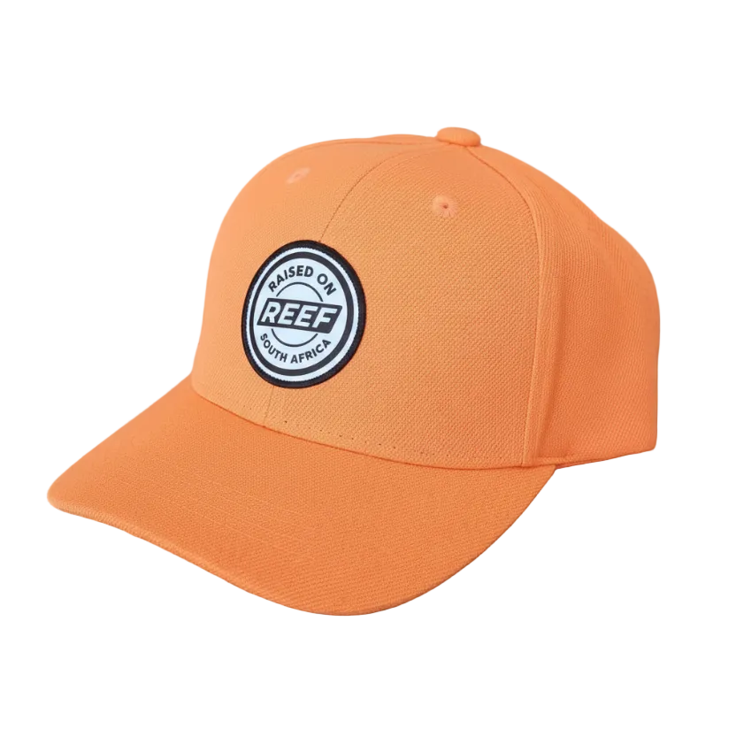 Orange cap with a logo on a wooden surface