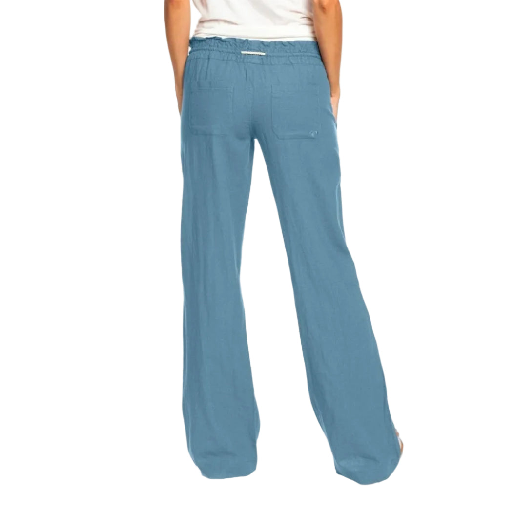 Blue pants worn by a person on a white background