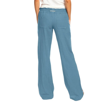 Blue pants worn by a person on a white background